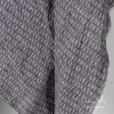 Na melanżowym czarnym tle wytkana biała "jodełka".