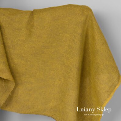 Musztardowa tkanina lniana w drobny wzorek.