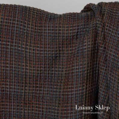 Melanżowa fioletowo - brązowa tkanina. Wzór waflowy.