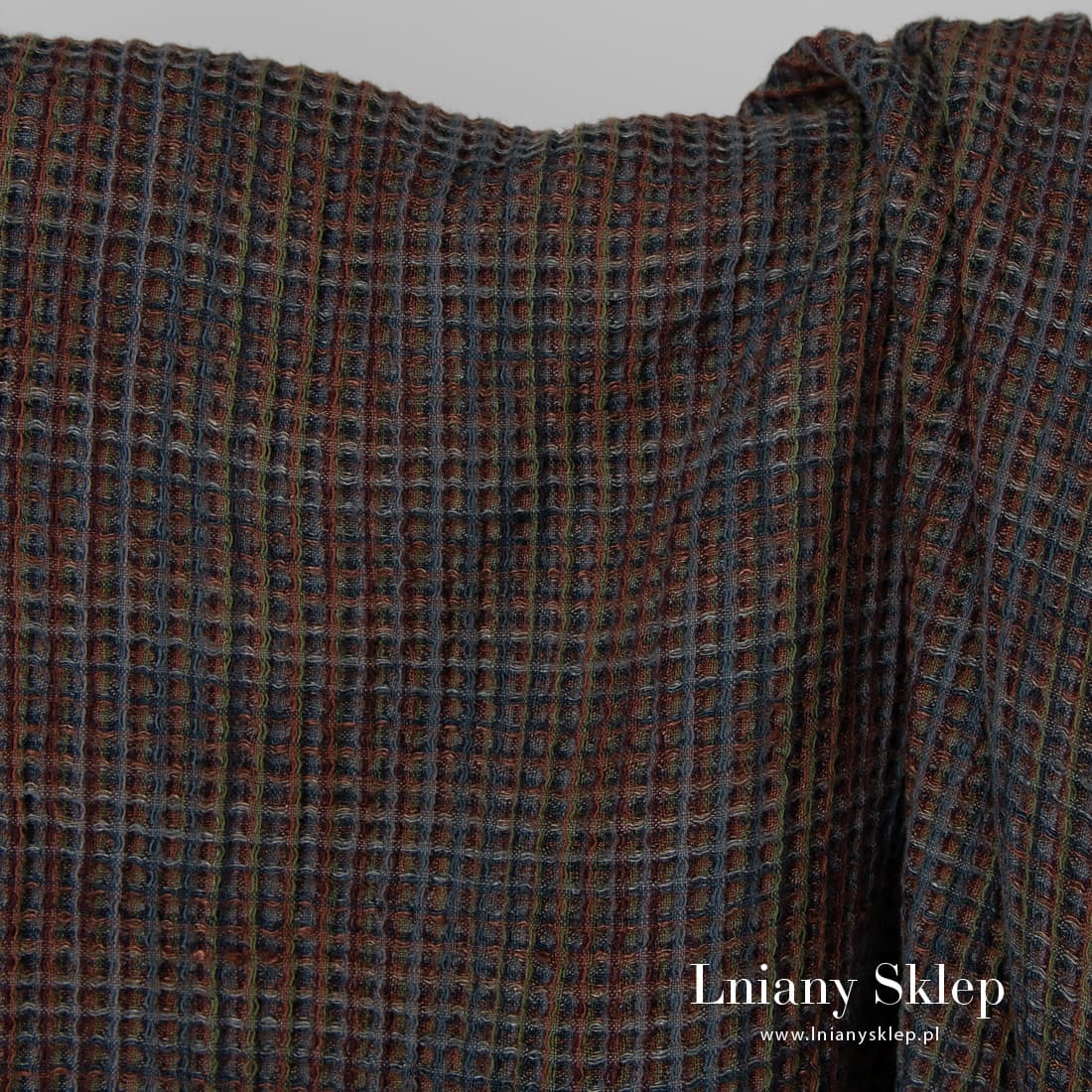 Melanżowa fioletowo - brązowa tkanina. Wzór waflowy.