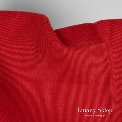 Czerwono - pomarańczowa tkanina lniana.