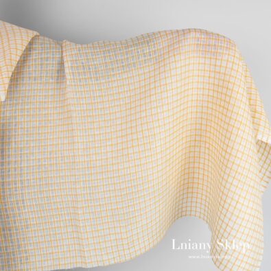 Tkanina lniana w żółtą i białą kratkę.