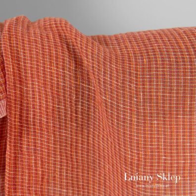 Prześwitująca pomarańczowa tkanina w paski.