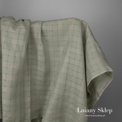 Zielona w przeźroczystą kratkę tkanina lniana.