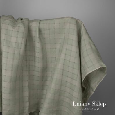 Zielona w przeźroczystą kratkę tkanina lniana.
