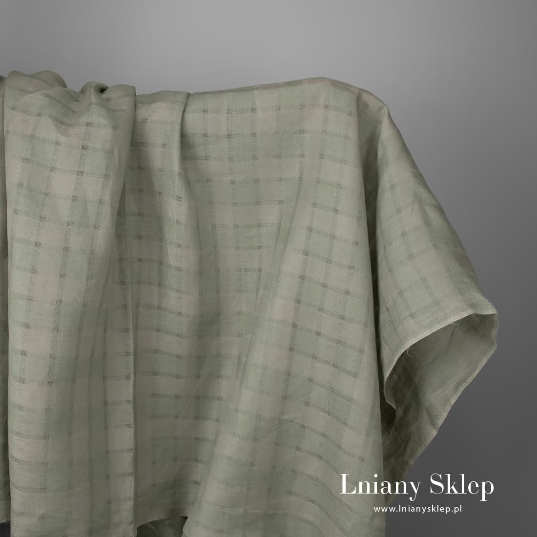 Zielona w przeźroczystą kratkę tkanina lniana.