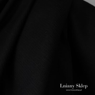 Czarna tkanina wytkana splotem waflowym.