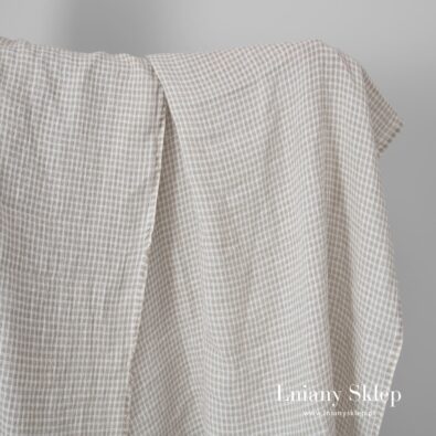 Niebarwiona w prześwitującą krateczkę tkanina lniana.