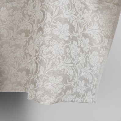 Beige puolipellavainen kangas jacquard jossa on kukkia soveltuu vaatteiden ja kodintekstiilien ompeluun