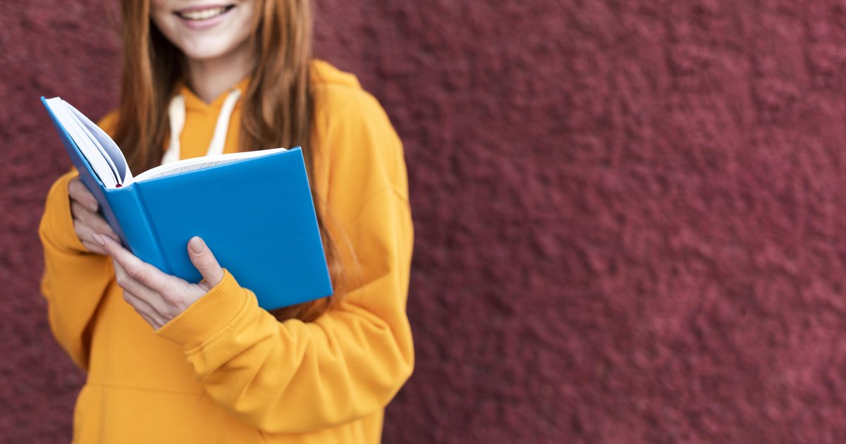 redhead-woman-reading-from-book-with-copy-space