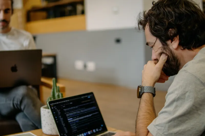 Coding at a laptop in the office