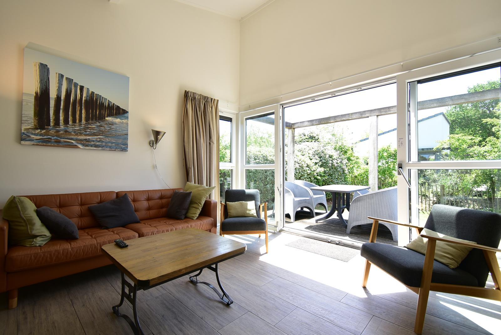 kopen-vrijstaande-vakantiewoning-ouddorp-woonkamer-schuifpui-en-terraszicht-recreatieadviseurs-vakantiehuistekoop-nl.jpg.JPG