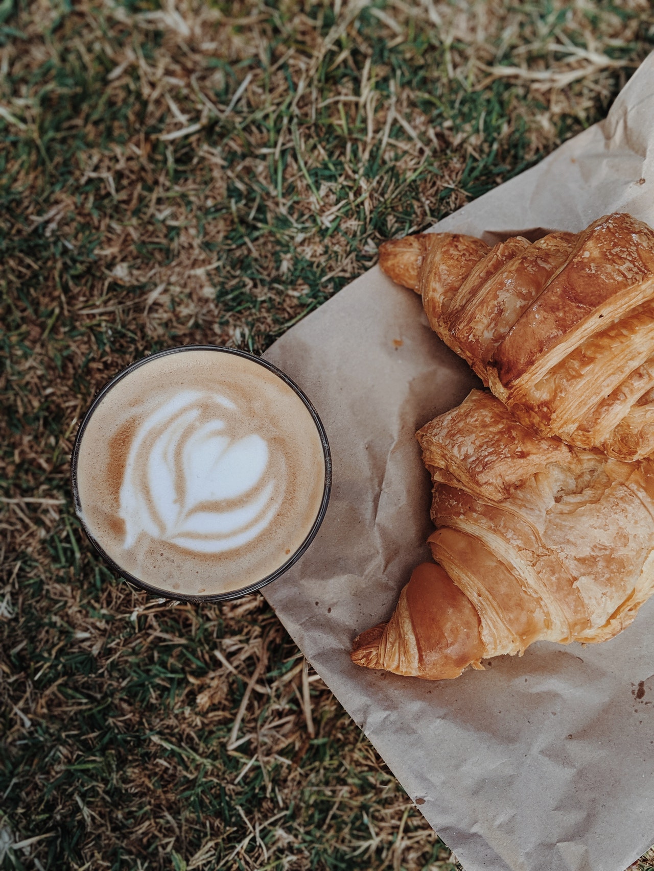 cappuccino-by-croissant-on-ground-2974486