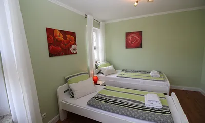 Grünes Schlafzimmer mit 2 Doppelbetten