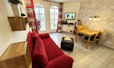 Wohnbereich mit einer Essecke, gemütlicher Couch (Aufbettung für 3./4. Person 1,60 m x 2,00 m), Smart-TV, Blu-Ray-Player und Musikanlage mit DAB Radio