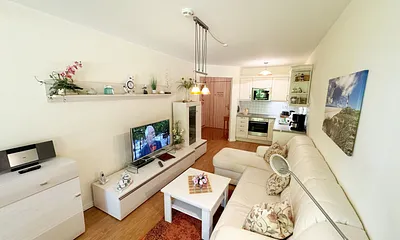 Wohnbereich mit gemütlicher Couch, Leselampe, Smart-TV, DVD-Player und Radio mit CD