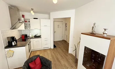 integrierte helle Küchenzeile mit Backofen, Ceranfeld, Spülmaschine, Kühlschrank, Nespresso Maschine, Kaffeemaschine, Toaster, Wasserkocher und anderen praktischen Helfern