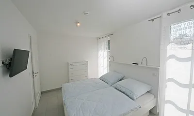 Schlafzimmer mit Doppelbett (1,80 m x 2,00 m), Flachbild TV und einem Kleiderschrank