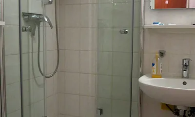 Bad mit Dusche, Handwaschbecken und WC