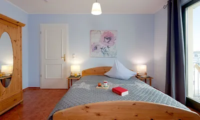 Schlafzimmer mit Doppelbett und Balkon