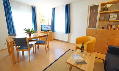 Wohnzimmer mit Esstisch und TV