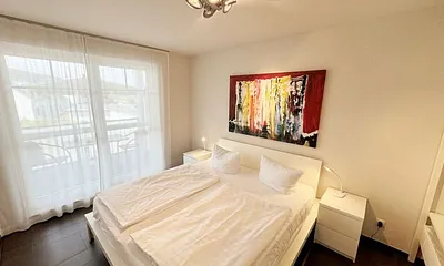 Schlafzimmer mit Doppelbett (1,80 m x 2,00 m), offenem Schranksystem sowie zusätzlichen Spiegelschrank