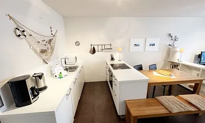 Küchenbereich mit Cerankochfeld, Backofen, Geschirrspüler, Kühlschrank, Kaffeemaschine, Mikrowelle, Wasserkocher, Mixer, Toaster und umfangreiche Küchenausstattung