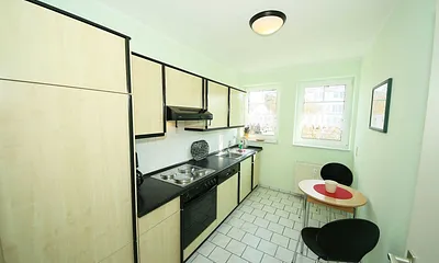 separate Küche mit Cerankochfeld, Backofen, Spülmaschine, Kühlschrank mit Eisfach, Ablufthaube, Mikrowlle, Wasserkocher, Kaffeemaschine, Toaster