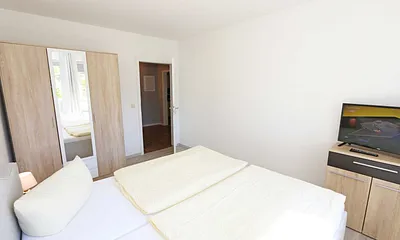 Schlafzimmer mit Doppelbett und Kleiderschrank