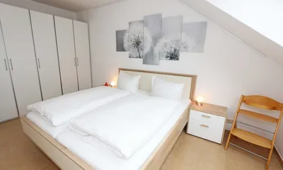 Schlafzimmer mit Doppelbett (1,80 m x 2,00 m), Nachttischablagen, Kleiderschrank sowie einen weiteren Smart-TV welcher aber nur zum Streamen genutzt werden kann