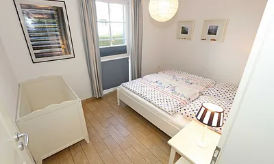 Schlafzimmer mit einem Doppelbett (1,80 m x 2,00 m), Qualitäts- Latexmatratzen, verstellbarem Lattenrost, Kleiderschrank und Verdunklungsplissees 