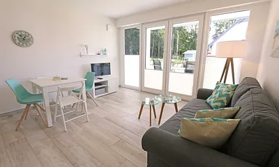 Wohnbereich mit Couch (voll funktionstüchtiges Bett mit Lattenrost und Matratze - Liegefläche 1,60 m x 2,00 m),Couchtisch,Sideboard,Leselampe,Flachbild-TV mit  Blu-Ray Player & Micro-Hifi System