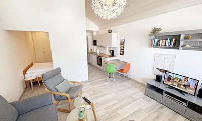 gemütliches Wohnzimmer mit Couch und blick ins Schlafzimmer