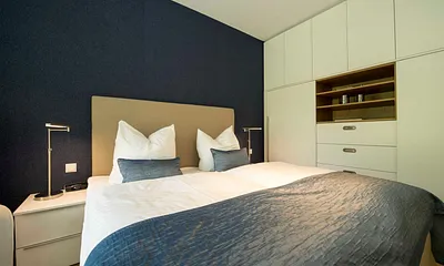 Schlafzimmer mit bequemen Doppelbett mit 4 Gang-Bonell-Federkern Matratzen (1,80 m x 2,00 m), Kleiderschrank, Nachttischablagen, Safe, Wecker und Verdunklungsmöglichkeit