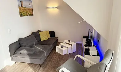 Wohnbereich mit Couch, Kaminofen, Smart-TV, Blu-Ray-Player u.a. mit CD- und Radiofunktion sowie Gesellschaftsspielen