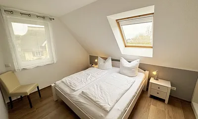 Schlafzimmer mit Doppelbett (1,80 m x 2,00 m), Kleiderschrank und Komode