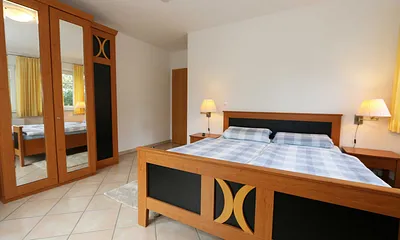 Schlafzimmer mit Doppelbett (1,80 m x 2,00 m), verstellbare Lattenroste, 2 Nachtschränken, Flachbild-TV und Kleiderschrank / Von hier aus blicken Sie auf das Naturschutzgebiet 