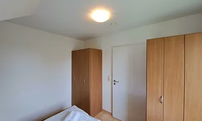 Schlafzimmer mit Doppelbett und Kleiderschrank