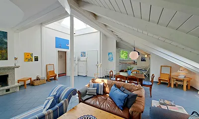 großzügiger Wohn- und Essbereich mit Leseecke, Kamin, Esstisch und offener Küche