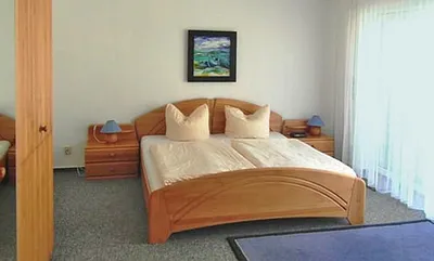 Schlafzimmer mit Fenster zum Wald