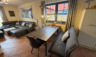 Der großzügige Wohn-Eßbereich mit großem Eßtisch und gemütlicher Couchgarnitur.