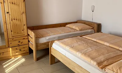 Schlafzimmer mit einem Doppelbett 1,60m x 2,00m sowie Einzelbett 0,90m x 2,00m und Kleiderschrank