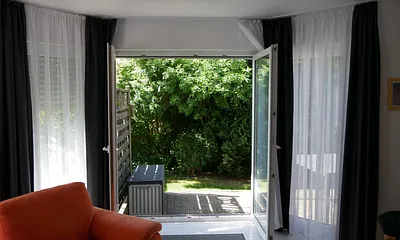 Vom Wohnzimmer aus können Sie großzügig auf die Terrasse gelangen (oder auch die Sonne hereinlassen).