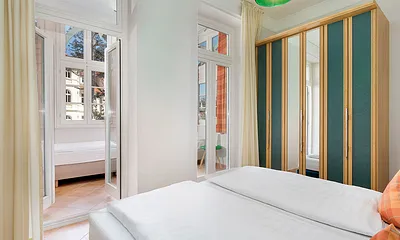 ... und einen Austritt in den Wintergarten, in dem zwei Einzelbetten stehen.