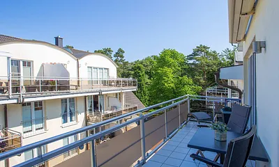 Sonniger Balkon mit Markise und Schattenplus und Blick zum Meer