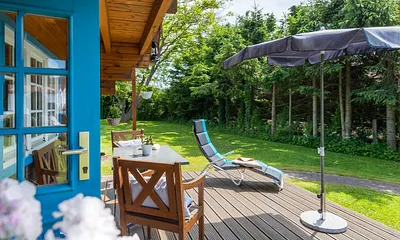 Die Terrasse ist komfortabel möbliert. Auch die Wiese am Haus kann als Liegewiese genutzt werden.