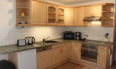 Moderne Küchenzeile mit Glaskeramikherd, Grill, Geschirrspüler, Mikrowelle, Wasser-/ Eierkocher, Kaffeemaschine, reichhaltige Geschirrausstattung