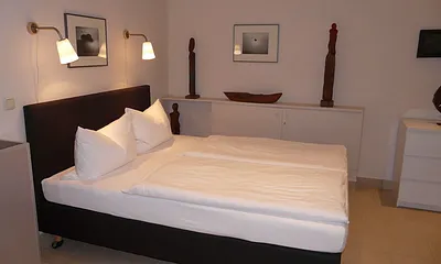 Schlafbereich mit Doppelbett (Hotel-Boxspringbett mit Bandscheiben-Federkernmatratze, 1,60 m x 2 m), Kommode, Kleiderschrank