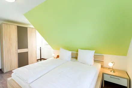 Schlafzimmer mit Doppelbett und Kleiderschrank