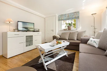 Das schöne helle Wohnzimmer hat einen großen Flachbild-TV, DVD-Player und Radio mit CD-Player.